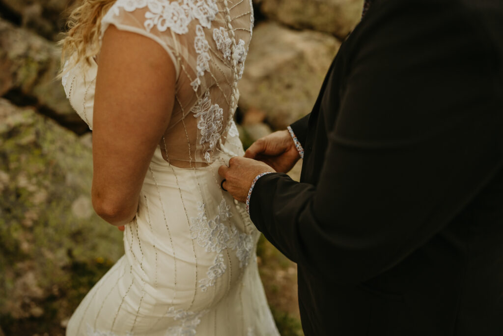 wedding details of zipping the dress