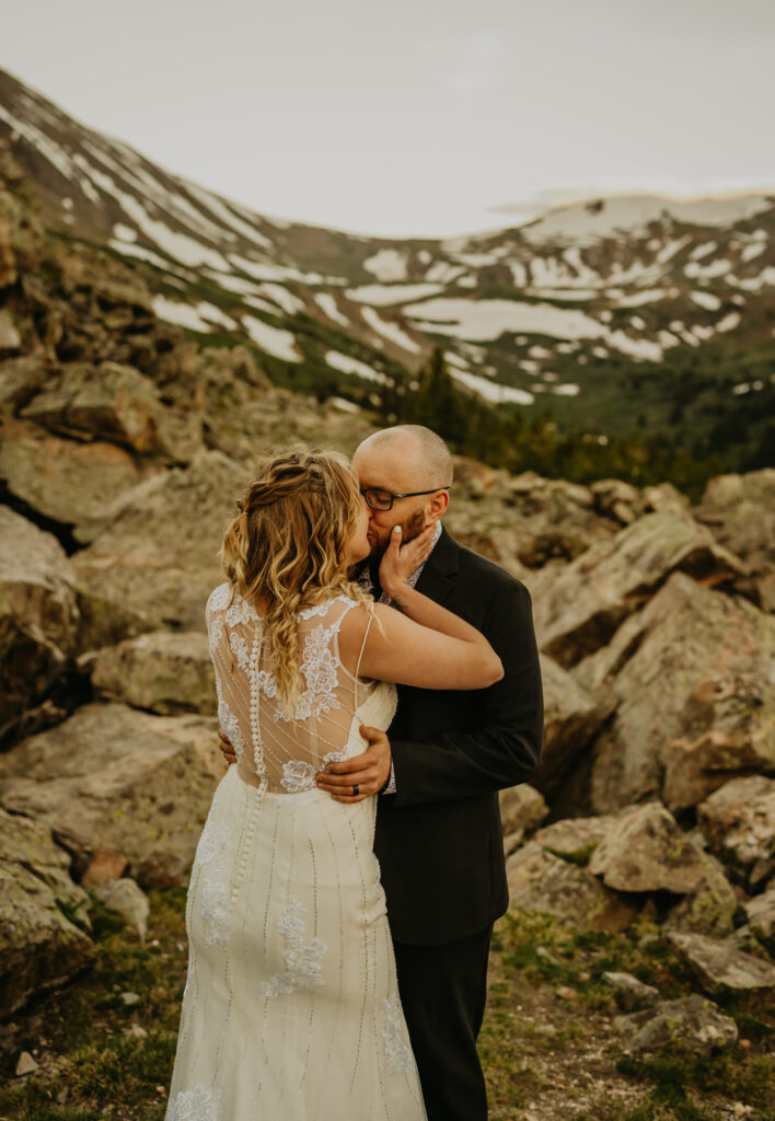 couple sharing first kiss at the top of silver dollar lake